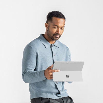 A person sitting at a table with a tablet.