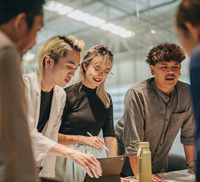 A group of people looking at a tablet.