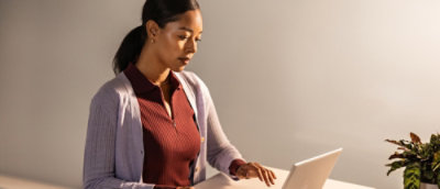 A woman is working on a laptop.